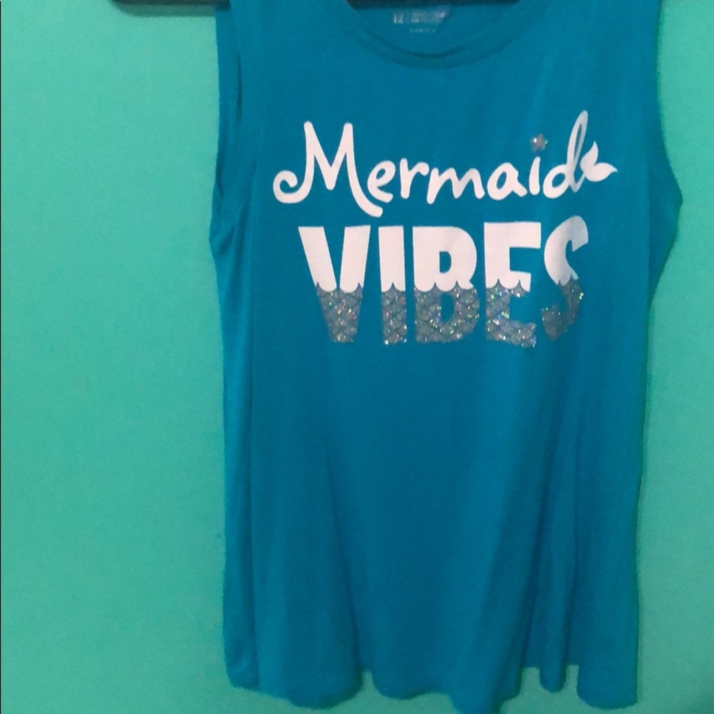 A blue tank top that says mermaid vibes